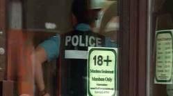 A police officer can be seen inside the compassion club on St. Laurent boulevard in Montreal. (CBC Photo)